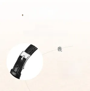 Macro detail of high-quality black litchi grain leather strap with silver pin buckle
