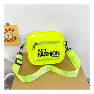 Detailed close-up of glossy neon green crossbody bag with wide letter-printed strap