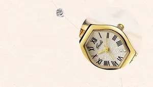 Detail of Gedi women's gold barrel-shaped watch with Roman numerals and textured dial