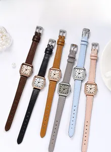 Detailed flat lay of small square quartz watches with vintage leather straps in multi colors