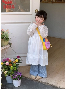 Detailed view of a trendy multi-colored mini crossbody bag for kids in an outdoor setting