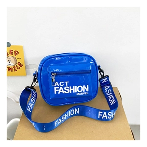 Detail of blue patent leather kids crossbody bag with printed wide shoulder strap