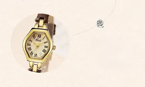 Close-up of retro gold tonneau case with Roman numeral dial and dark brown leather strap