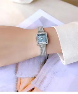 Detail of elegant silver square watch featuring a blue mother-of-pearl dial and crystals