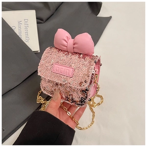 Detail of pink sequin mini chain bag with a leather bow and embossed arin label