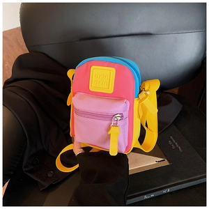 Close-up of kids' colorful nylon mini bag showing multi-color fabric and zipper details