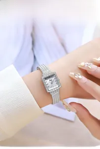 Close-up of women's square quartz watch with a diamond-set bezel and mother of pearl dial