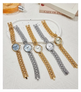Close-up of five vintage GEDI quartz watches with Roman numerals on a stylish tray