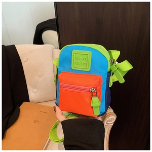 Detail of colorful mini crossbody bag with logo patch and vibrant neon green strap