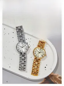 Close-up of retro GEDI watches with Roman numerals and sunray dials in gold and silver