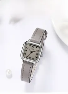 Detail of square quartz watch with Morandi grey leather strap and minimalist dial