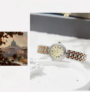 Detail of GEDI women's quartz watch with two-tone steel band and Roman numerals