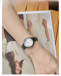 Close-up of elegant retro lady watch with blue hands and embossed leather strap