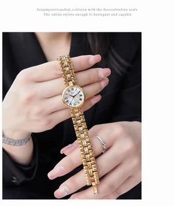 Close-up of GEDI vintage gold watch with Roman numerals on white dial and chain strap