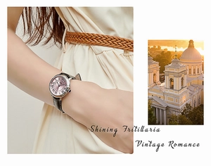 Macro view of vintage watch with pink mother-of-pearl dial and sapphire crown detail
