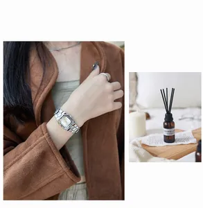 Silver square quartz watch for women with metal chain strap worn on wrist lifestyle view