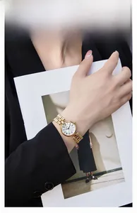 Detailed shot of a vintage gold women's watch with Roman numerals on a small round dial