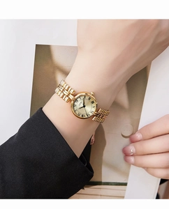 Detail of vintage GEDI gold roman numeral watch worn by a model on a magazine background