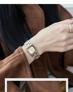 Close-up of square quartz watch with two-tone steel band and roman numerals on dial