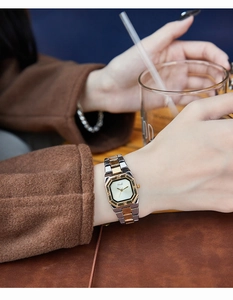Close-up of vintage square quartz watch with two-tone metal strap and Roman numerals
