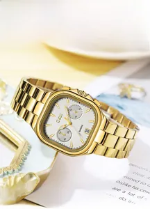 Close-up of gold steel square watch with calendar window and five-hand quartz movement