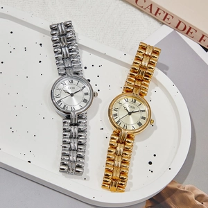 Vintage GEDI roman numeral quartz watches in silver and gold on white tray