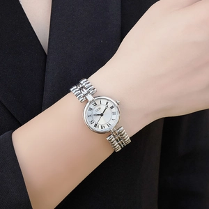 Vintage silver quartz watch for women with round Roman numeral dial on a metal strap