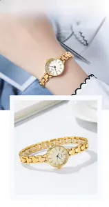 Close-up of elegant gold metal watch with small round dial and blue hands for women