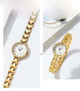 Detailed view of women's gold quartz watch with a small white dial and metal link bracelet