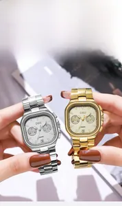 Detail view of GEDI square dial watches with gold and silver link bands and date display