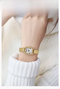 Détail de la montre à quartz carrée avec bracelet doré et lunette en strass