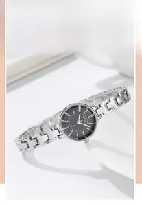 Detail of GEDI fashion watch featuring silver mesh strap and black dial on ceramic prop