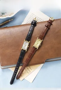 Close-up of vintage women's square quartz watches with crocodile pattern leather straps