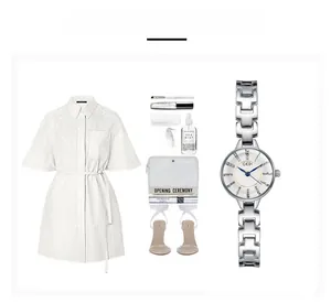 Elegant silver steel watch with white dial and blue hands displayed with fashion accessories