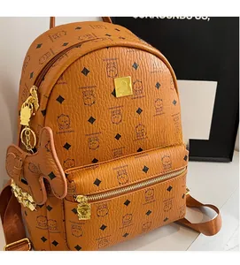 Close-up of brown backpack with cute bear print, gold studs, and textured leather finish