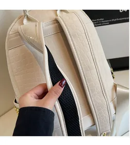Detail of crocodile textured strap and breathable mesh lining of the off-white backpack