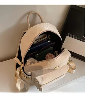 Detail of spacious interior of off-white woven backpack holding tablet and daily items
