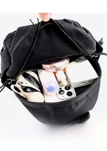 Close-up of the spacious interior compartment of the black backpack for travel storage