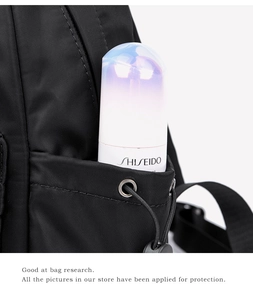 Detail view of nylon travel backpack side pocket with drawstring and metal eyelets