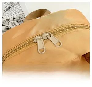 Detail shot of smooth double zippers on the yellow nylon school backpack for kids