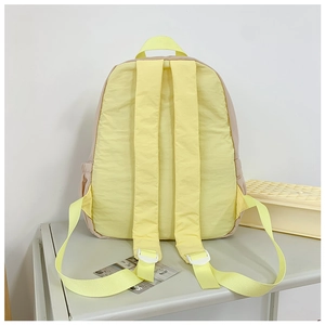 Detail of adjustable padded shoulder straps and side pocket on this kids' school backpack