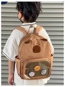 Detail of cute khaki backpack featuring bear embroidery and transparent PVC pocket