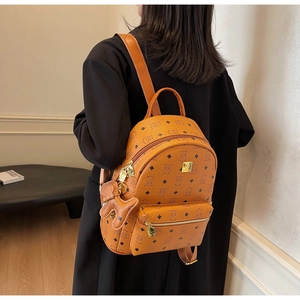 Detailed view of the cute bear print backpack with leather texture and bear charm