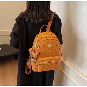Detail view of large capacity backpack featuring cute bear print and golden rivets