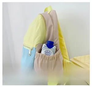 Detail view of the contrast color kids backpack with an elastic side pocket for water bottles