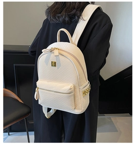 Detail of cream woven leather backpack with gold metal zippers and side stud accents