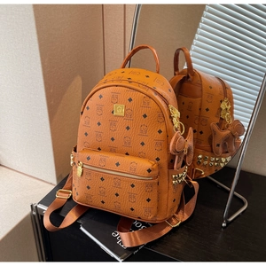 Detailed view of cognac PU leather backpack with bear prints and gold rivet accents