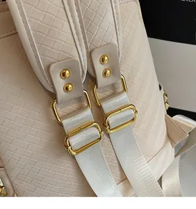 Detail of woven texture fabric with adjustable golden metal buckle on beige backpack