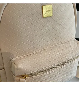 Detailed close-up of cream woven backpack texture and golden VIDPALO logo hardware