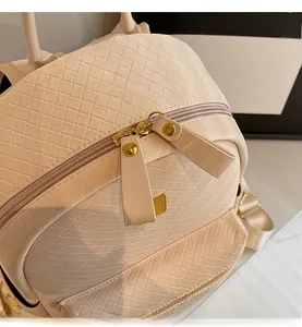 Detail showing woven PU leather texture and smooth dual zipper with gold metal rivets